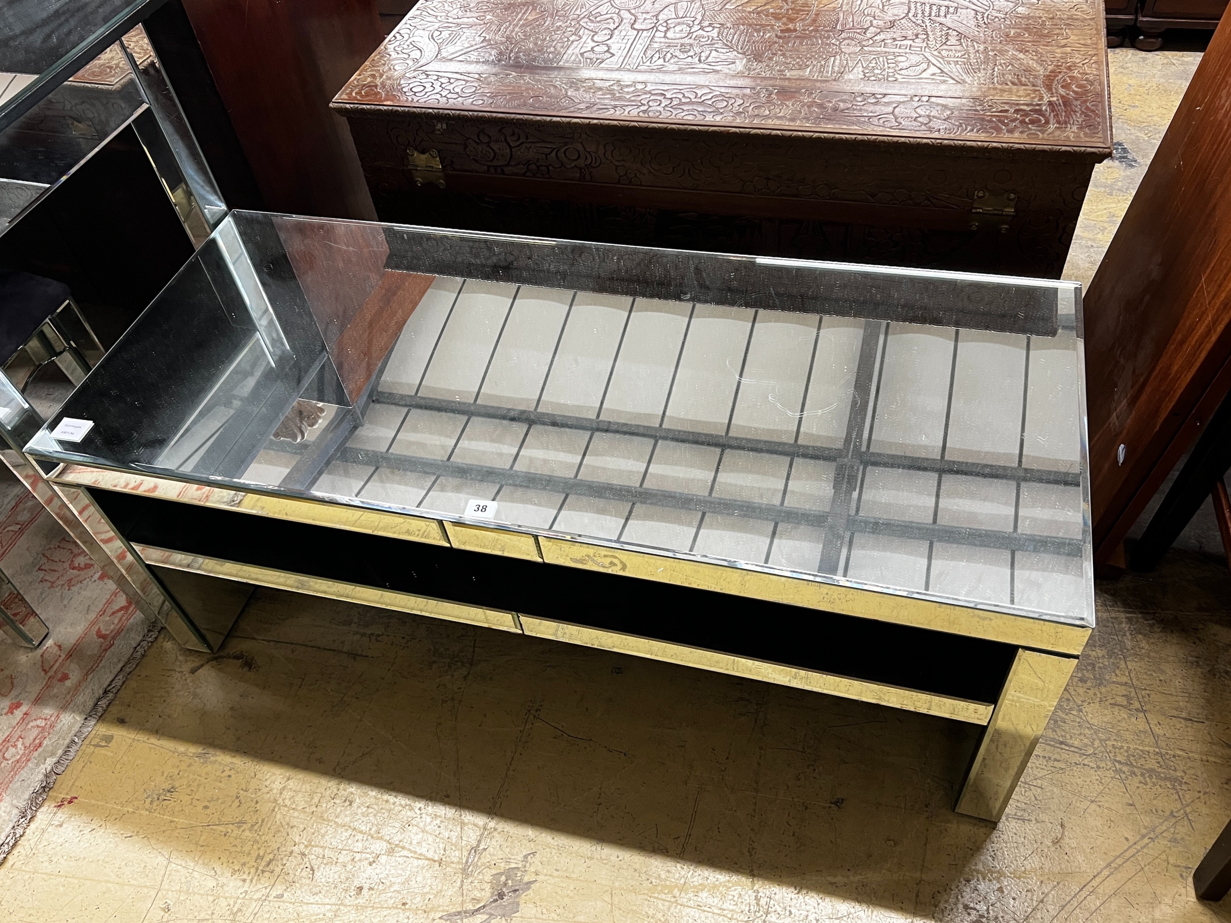 A contemporary mirrored coffee table, width 120cm, depth 50cm, height 46cm